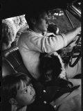 Senator Robert Kennedy Driving Car with Pet Springer Spaniel over His Lap and Son Max Beside Him Photographie par Bill Eppridge