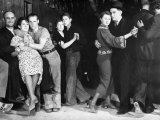 Construction Workers and Taxi Dancers Enjoying a Night Out in Barroom in Frontier Town Photographie par Margaret Bourke-White