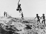 Bushman Children Playing Games on Sand Dunes Reproduction photographique sur papier de qualité par Nat Farbman