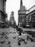 Man Feeding Pigeons in an Empty Times Square During a Taxi Strike Premium Photographic Print by Yale Joel