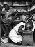 Kneeling Schoolgirl Writing on Wooden Bench. Accura, Gold Coast, Ghana Premium Photographic Print by Alfred Eisenstaedt