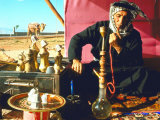 Arab Shepherd Smoking His Hookah as He Relaxes in a Roadside Tea Tent Premium Photographic Print by Carlo Bavagnoli