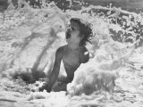 Exuberant Young Girl Getting Splashed by a Wave in the Surf at Jones Beach Photographic Print by Alfred Eisenstaedt