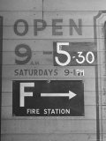 Sign Repainted to Show Earlier Closing Time For a Business Due to Mandatory Blackout in Evening Lámina fotográfica por David Scherman