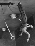 Intercollegiate Champion Gymnast Newt Loken on Flying Rings Doing Reverse Flyaway with Half Twist Photographic Print by Gjon Mili