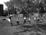 Uniformed Drum Major For the University of Michigan Marching Band Practicing His High Kicking Pranc Lámina fotográfica por Alfred Eisenstaedt