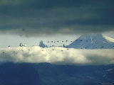 Flock of Geese Flying in Clouds Near Aghileen Peaks in the Izembeck Wildlife Range Photographic Print by John Loengard