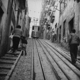 View Showing a Typical Street Scene in Lisbon Photographic Print by Bernard Hoffman