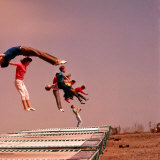 People Bouncing on Trampolines at Trampoline Center Photographic Print by J. R. Eyerman