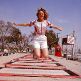 Young Woman Bouncing on Trampolines at Trampoline Center Photographic Print by J. R. Eyerman
