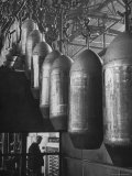 Line of 500 lbs Bombs Jiggling Along on Overhead Conveyor Hooks Abover Worker Premium Photographic Print by Andreas Feininger