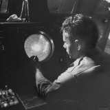 Man Looking at Radar Scope to Gather Weather Information Photographic Print by George Skadding