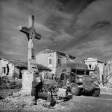 Soldier of British 8th Army Rests Against Battered Crossroads Crucifix Photographic Print by George Rodger