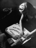 People Playing with a Ouija Board Photographic Print by Wallace Kirkland