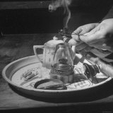 Customer Cooking Up the Opium to Prepare It For Smoking Photographie par George Lacks