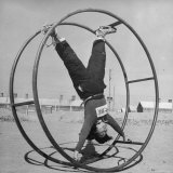 Girl Rolling in Large Wheel During Physical Education Class at North China Union University Photographic Print by George Lacks