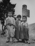 Children Standing in Front of Boundary Zone Sign Written in Russian, English, and Korean Premium Photographic Print by John Florea