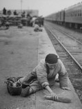 Aged Refugee Fighting Hunger, Sweeps Up Spilled Rice on the Railroad Station Platform Premium Photographic Print by Jack Birns