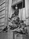 Children Playing on the Sculpted Lion at the Entrance of a Bank Premium Photographic Print by George Lacks