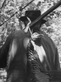 Hunter Carrying Dead Turkey Hung from His Rifle Premium Photographic Print by Gabriel Benzur