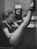 Dancer Mary Ellen Terry Talking with Her Legs Up in Telephone Booth Photographie par Gordon Parks