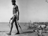 Australian Aborigine Man Bringing Back Two Monitor Lizards Known as Goannas to His Clan Premium Photographic Print by Fritz Goro