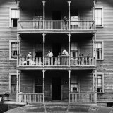 Family on Balcony of Apartment Building Photographie par Gordon Parks