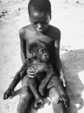 Baby Gorilla Named Bobo is Being Held by a Local Youngster Lámina fotográfica por Eliot Elisofon