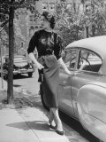 Katherine Cassidy Wearing a Red Fraostmann Wool Skirt and Black Sweater Beneath Black Cardigan Premium Photographic Print by Nina Leen