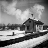 Small Railroad Station in Unidentified American Town, as Seen from Train Window Photographic Print by Walker Evans
