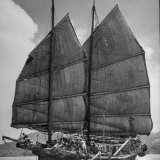 Junk Leaving Harbor with Patchwork Sails Up Photographic Print by Jack Birns