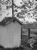 Small Child Running to the Outhouse at Rural School Photographie par Thomas D. Mcavoy
