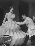 Buyer Sampling an Evening Dress on a Model to Check Its Quality Reproduction photographique sur papier de qualité par Nat Farbman