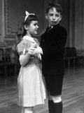 Girl at Ballroom Dancing Class Smiling at Her Partner Who Averts His Glance from Her Premium Photographic Print by Alfred Eisenstaedt