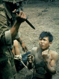 Bayonet Wielding South Vietnamese Soldier Menacing Captured Viet Cong Suspect During Interrogation Premium Photographic Print by Larry Burrows