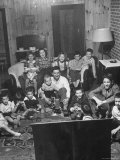 Family and Friends Gathering in Living Room to Watch Movies, Both Rented and Homemade Photographie par Gordon Parks