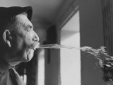 Wine Cellar Master and Taster Spitting Wine Premium Photographic Print by Carlo Bavagnoli