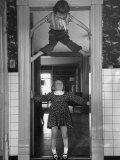 Denise Bruene Climbing Kitchen Door in Bare Feet, Her Hobby, Jan Bruene Says "Don't Fall on Me" Photographie par Gordon Parks