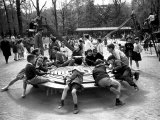 Parisian Children Riding Merry Go Round in a Playground Photographic Print by Alfred Eisenstaedt