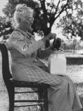 Old Woman in Gingham Dress Using Small, Modern Churn with Jar Sitting on Her Lap, on Farm Premium Photographic Print by George W. Ackerman