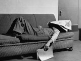 Writer Niven Busch Lying on Sofa with Newspaper over His Face as He Takes Nap from Screenwriting Photographie par Paul Dorsey