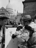 Street Artist Holding a Monkey Up to a Canvas So It Can Draw Premium Photographic Print by Alfred Eisenstaedt Street Artist Holding a Monkey Up to a Canvas So It Can Draw Premium Photographic Print by Alfred Eisenstaedt