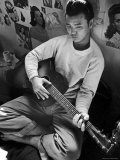 Young Japanese Nisei Playing Guitar in the Stockade at Tule Lake Segregation Center Premium Photographic Print by Carl Mydans
