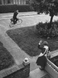Robert Neve Waving to His Wife While Riding Away on Bicycle Premium-Fotodruck von Hans Wild