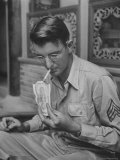 Military Man Lighting Cigarette with Bill Reproduction photographique sur papier de qualité par Jack Wilkes