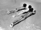 Three Native Boys Sunbathing Nude at the Edge of the Surf at Ocean Beach Premium Photographic Print by Howard Sochurek