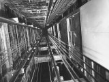 View Looking Up an Elevator Shaft Premium Photographic Print by Bernard Hoffman
