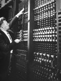 Technician Manipulating 1 of Hundreds of Dials on Panel of IBM's Room Size Eniac Computer Photographie par Francis Miller