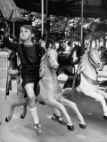 Young Turkish Prodigy Hassan Kaptan Riding a Merry Go Round Reproduction photographique sur papier de qualité par Gordon Parks