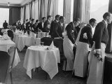 Waiters in the Grand Hotel Dining Room Lined Up at Window Watching Sonja Henie Ice Skating Outside Fotoprint van Alfred Eisenstaedt Waiters in the Grand Hotel Dining Room Lined Up at Window Watching Sonja Henie Ice Skating Outside Fotoprint van Alfred Eisenstaedt